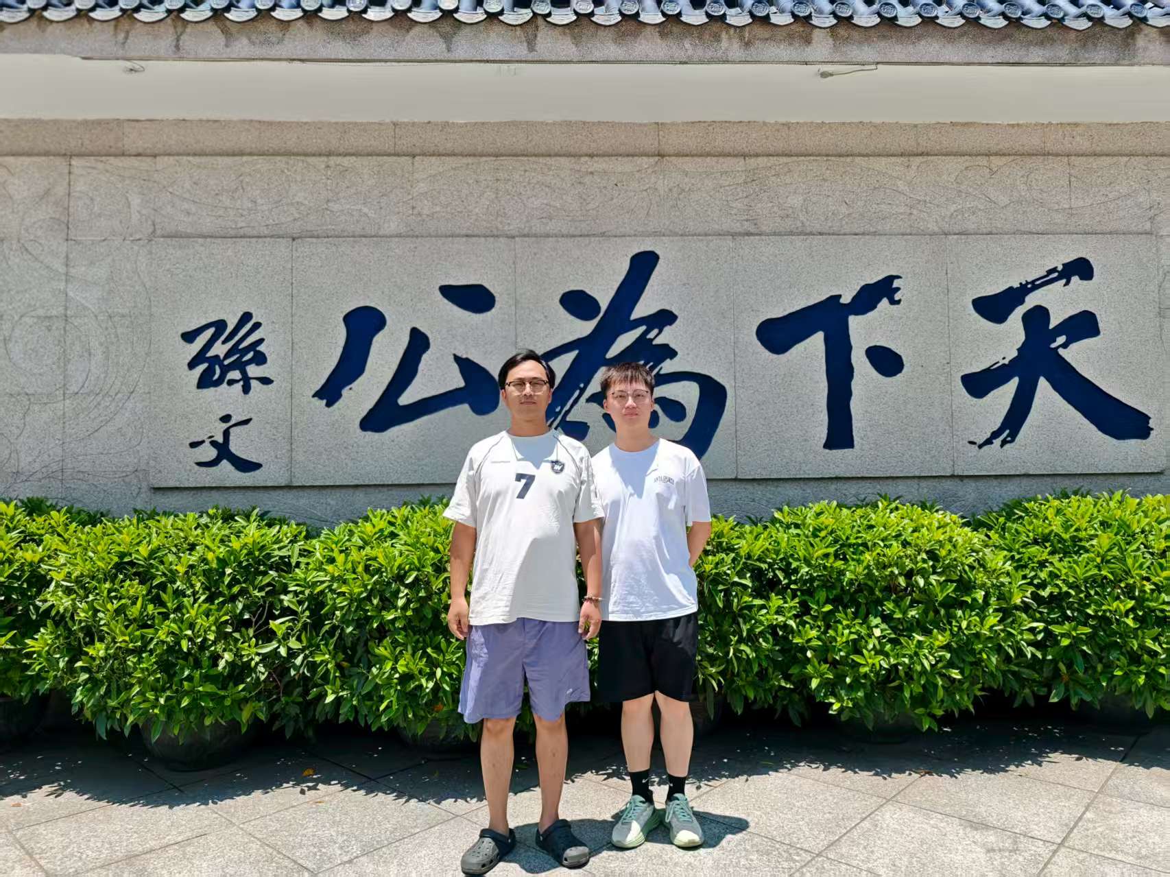 Two handsome boys in front of a monument